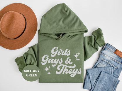 a green hoodie, jeans and a hat on a white surface