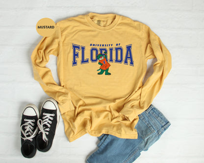 a yellow shirt with the word florida on it next to a pair of black shoes