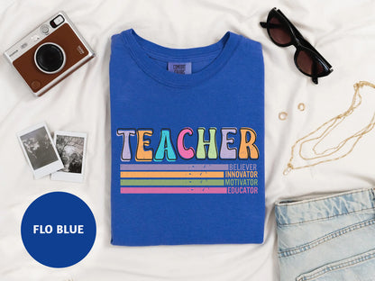 a t - shirt that says teacher on it next to a camera, sunglasses,