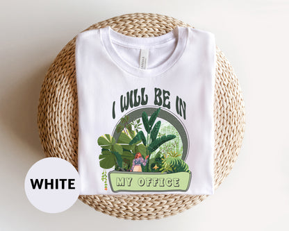 a white t - shirt with a picture of a house plant on it