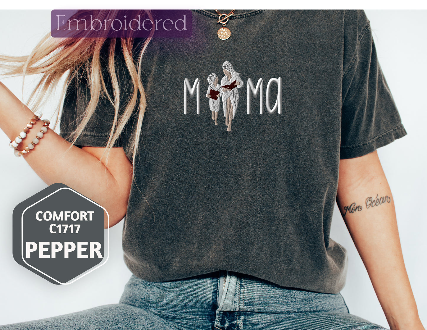 a woman wearing a black shirt with the word mama on it