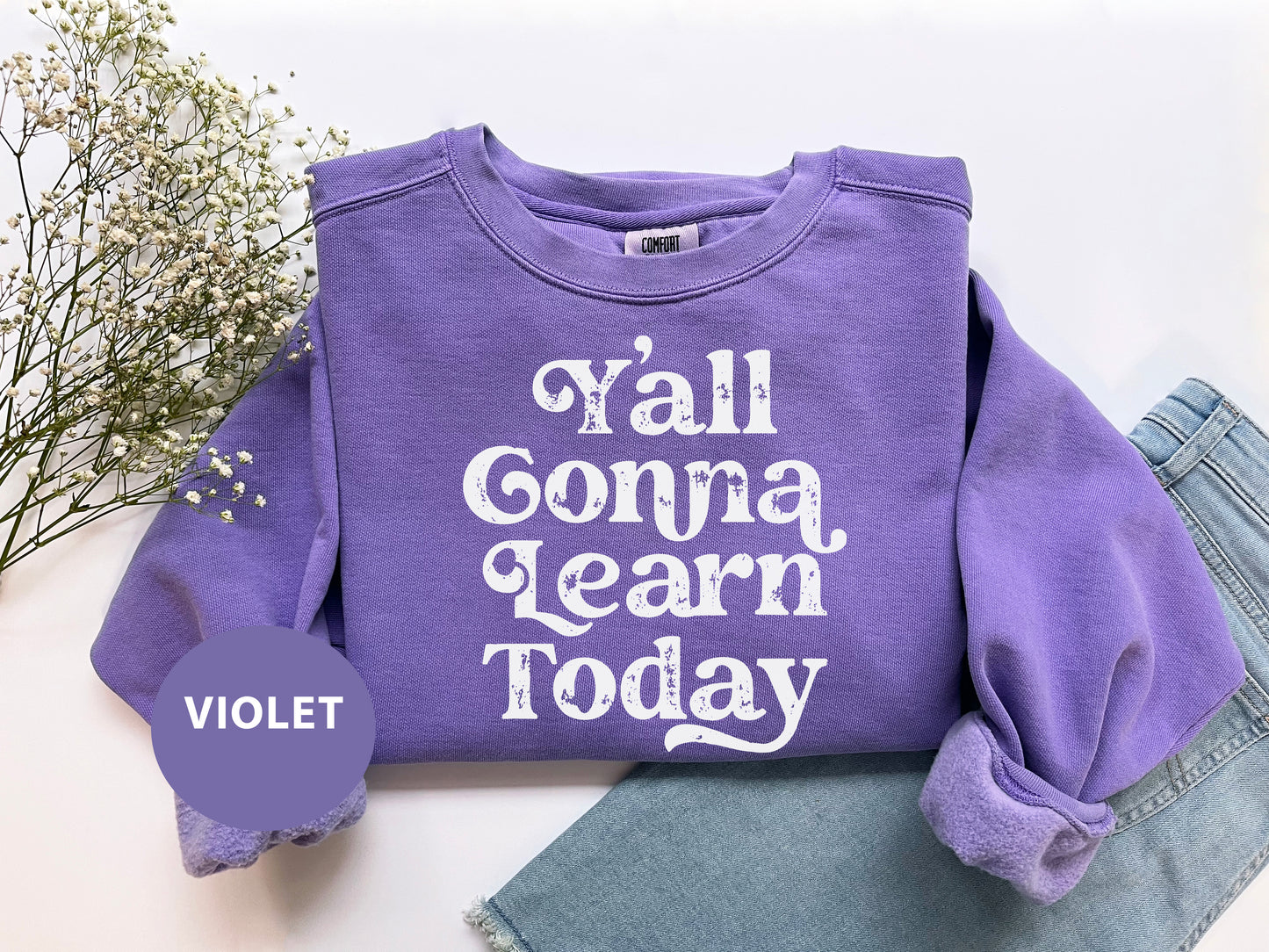 a purple shirt that says y'all gona learn today