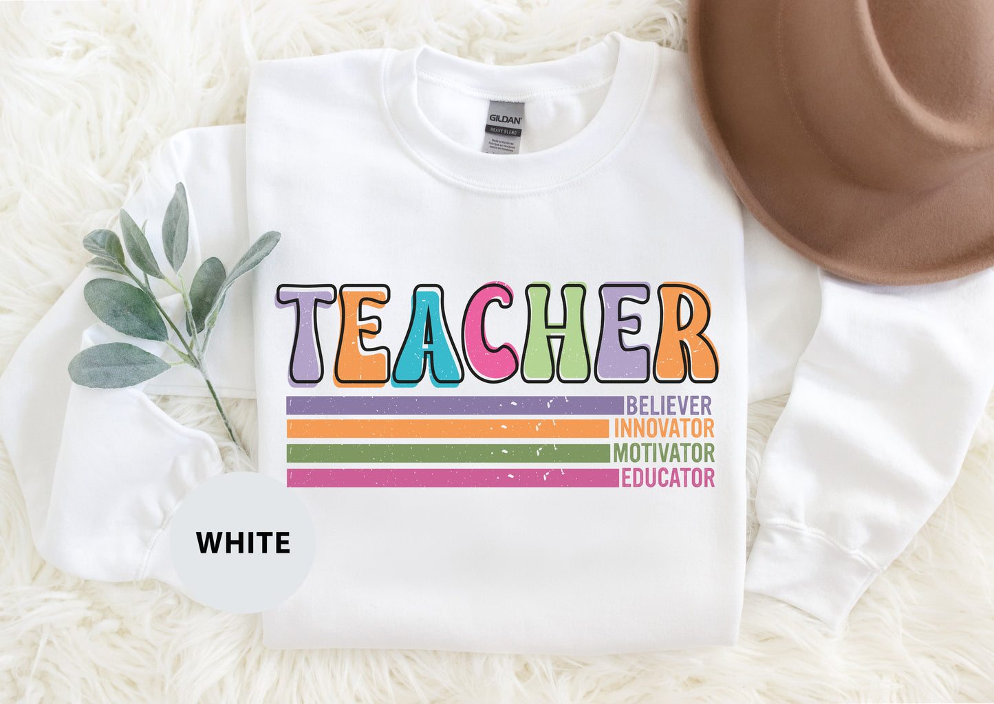 a teacher shirt with a hat on top of it