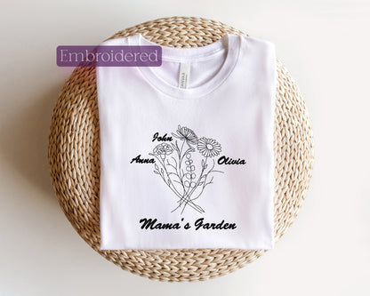 a white t - shirt with a picture of a flower and the words mama '