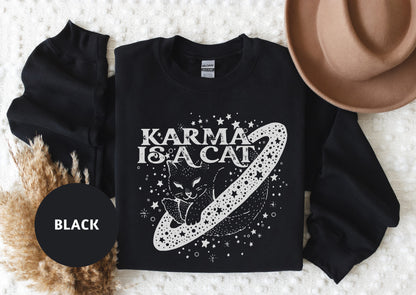 a black shirt with the words karma is a cat on it