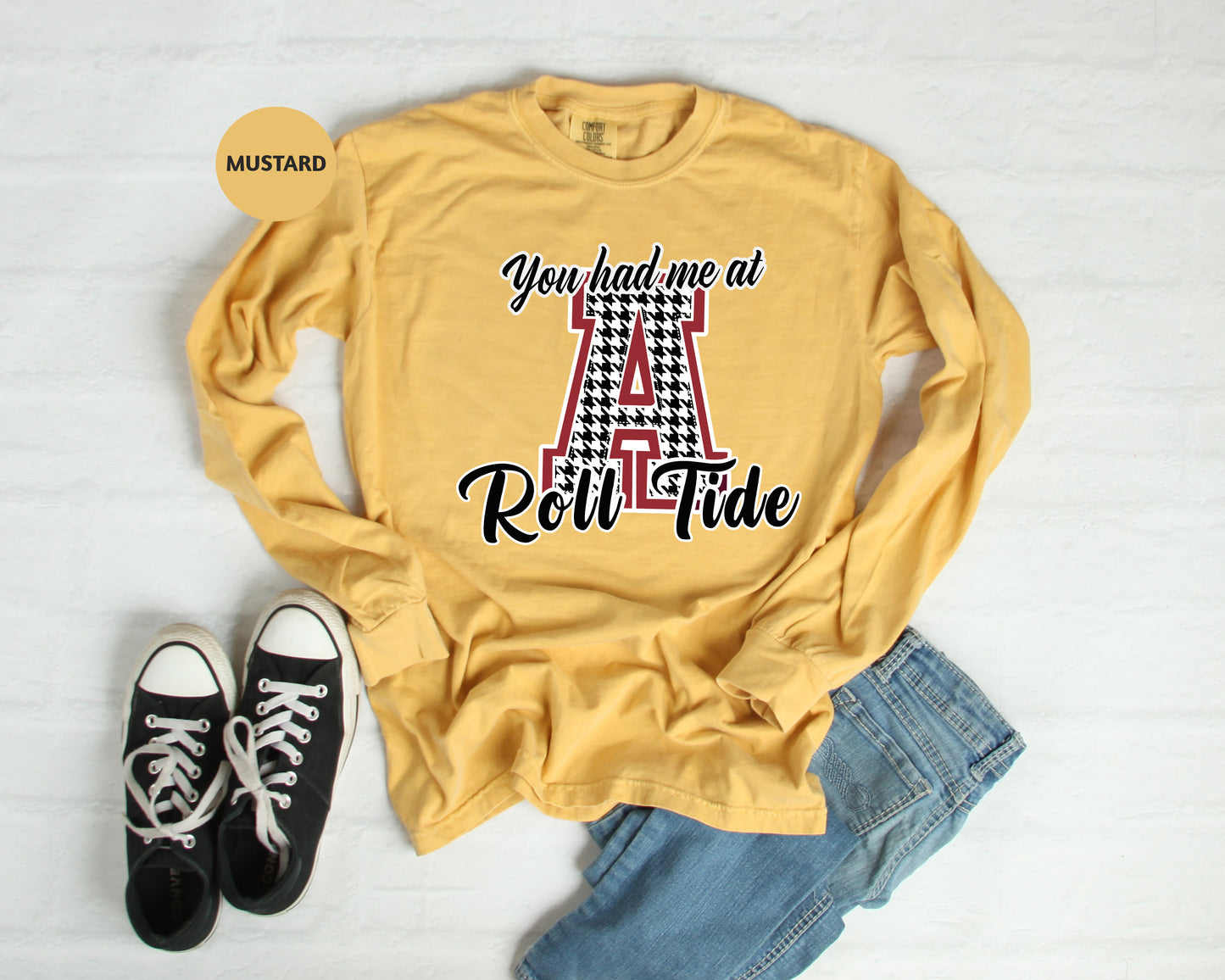 a t - shirt that says you had one at red tide next to a pair