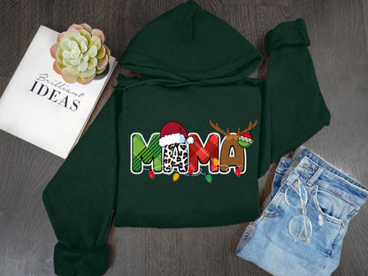 A green hoodie with the word "MOMA" printed on it, along with a pair of jeans and a book titled "Brilliant Ideas" on a wooden surface.