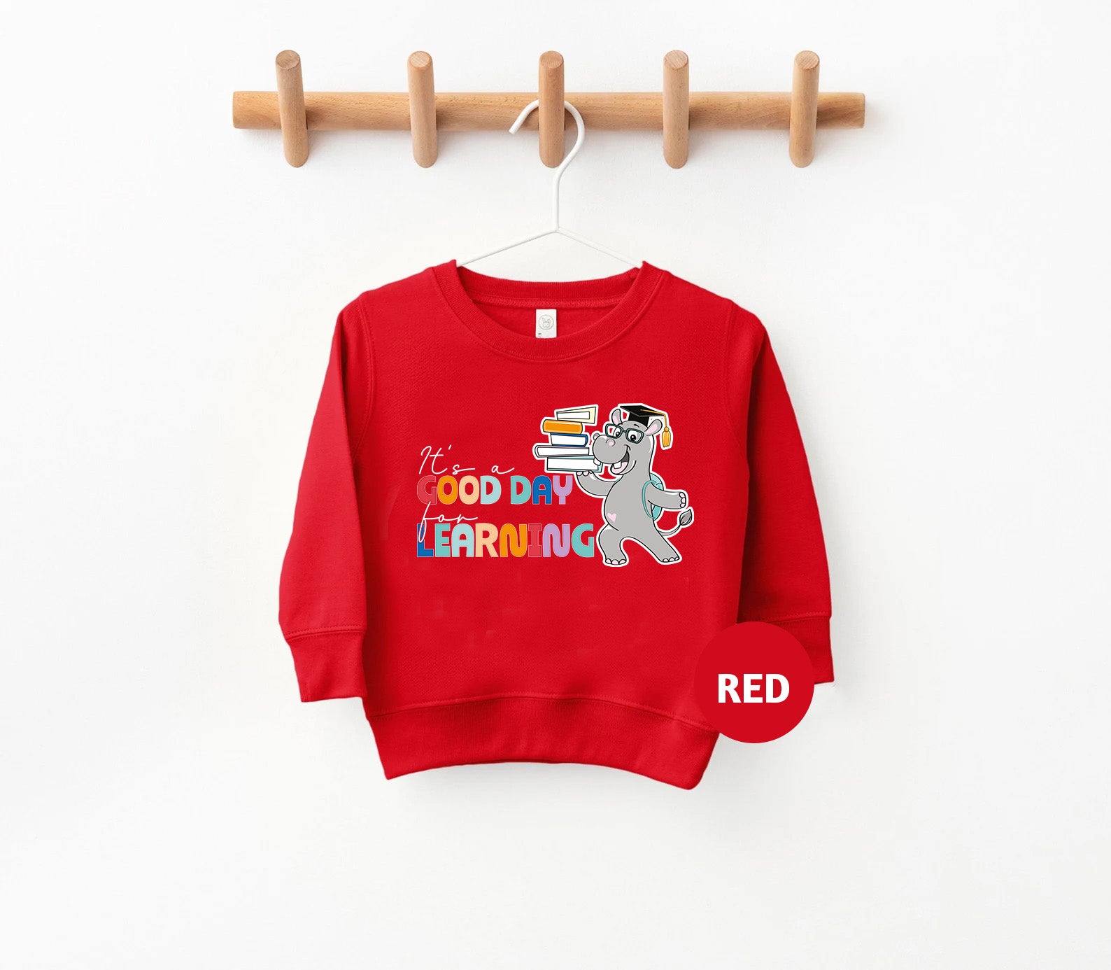 a red sweatshirt hanging on a clothes rack