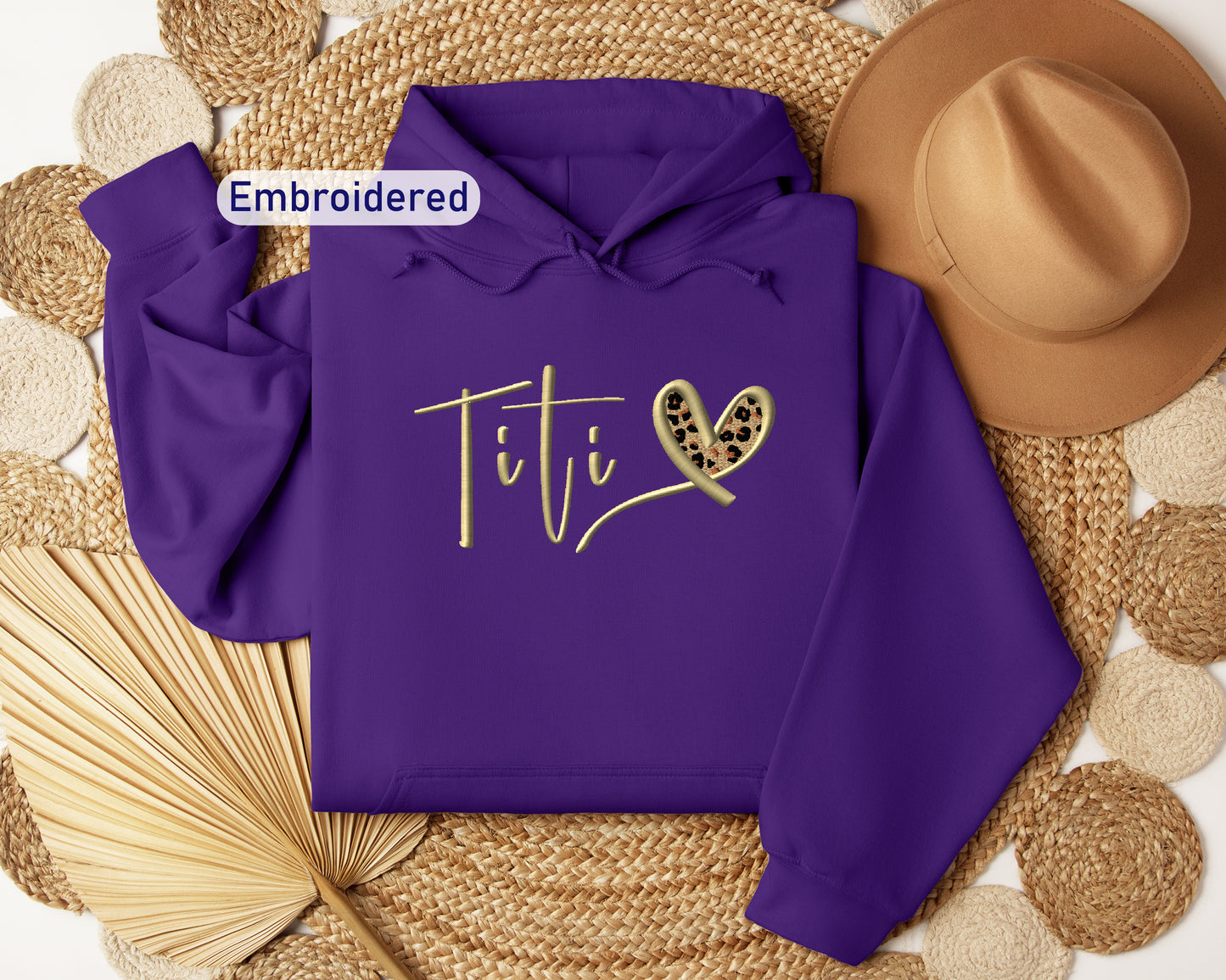 a purple hoodie with the word titi on it