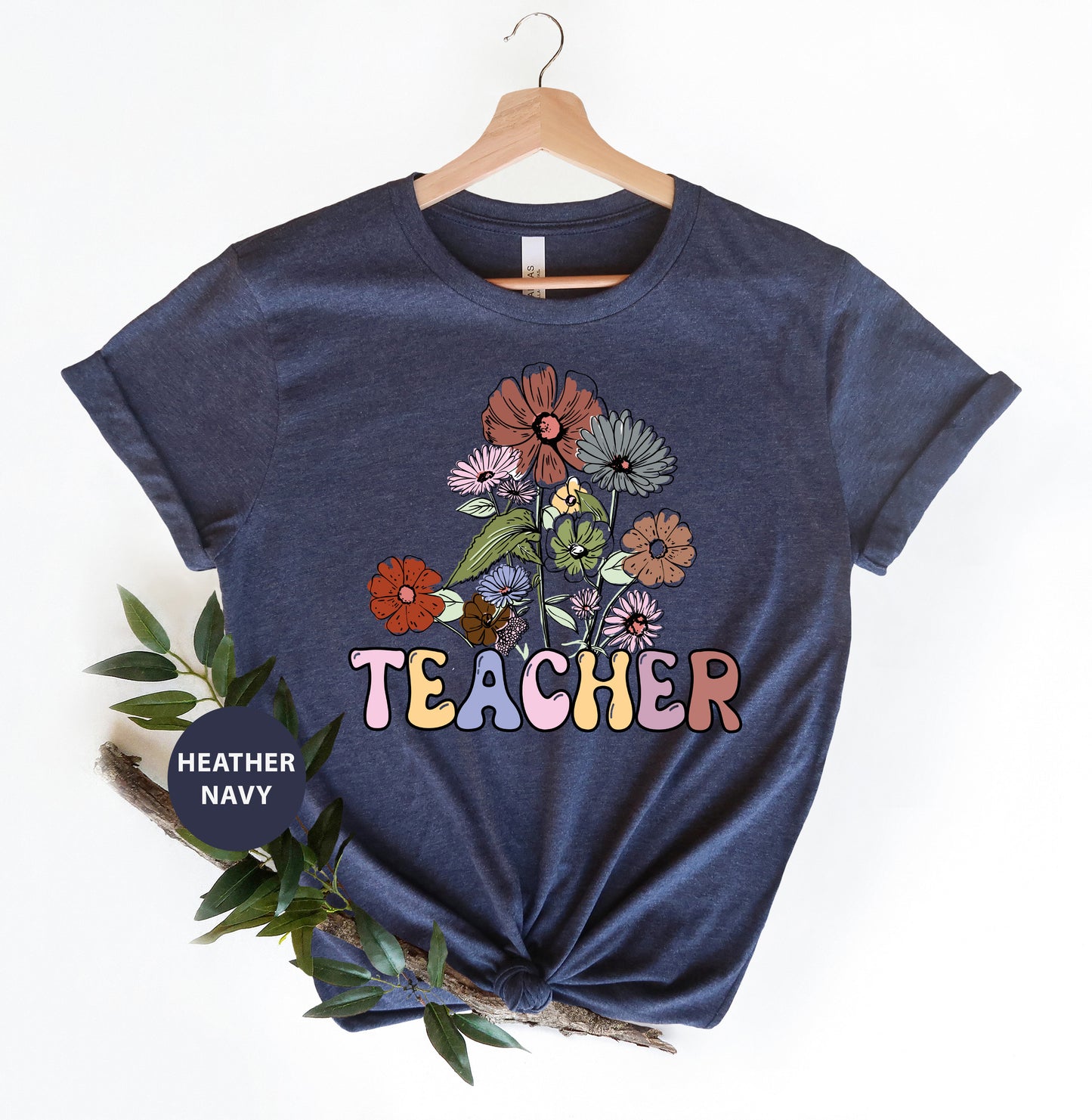 a t - shirt that says teacher with flowers on it