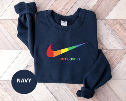 a navy sweatshirt with a rainbow nike logo on it