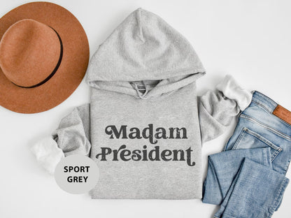 a gray hoodie with the words madam president printed on it