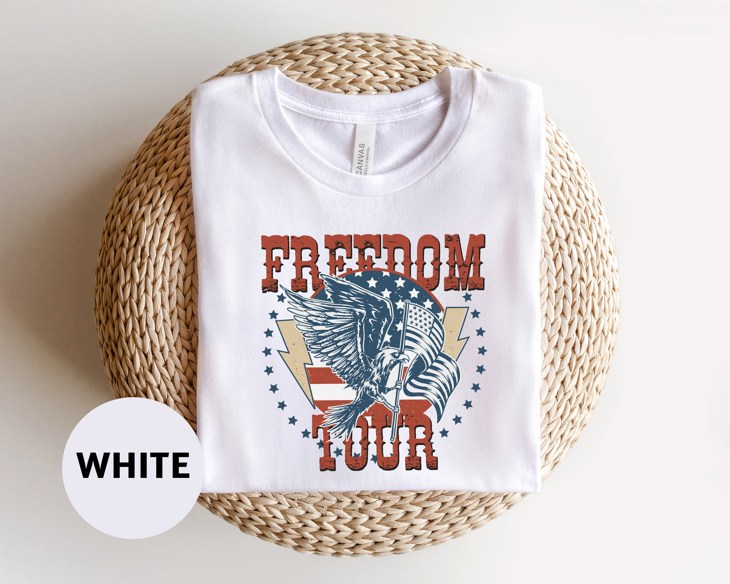 A white t-shirt with a graphic design featuring an eagle and the text "FREEDOM TOUR" printed on it.