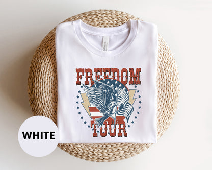 A white t-shirt with a graphic design featuring an eagle and the text "FREEDOM TOUR" printed on it.