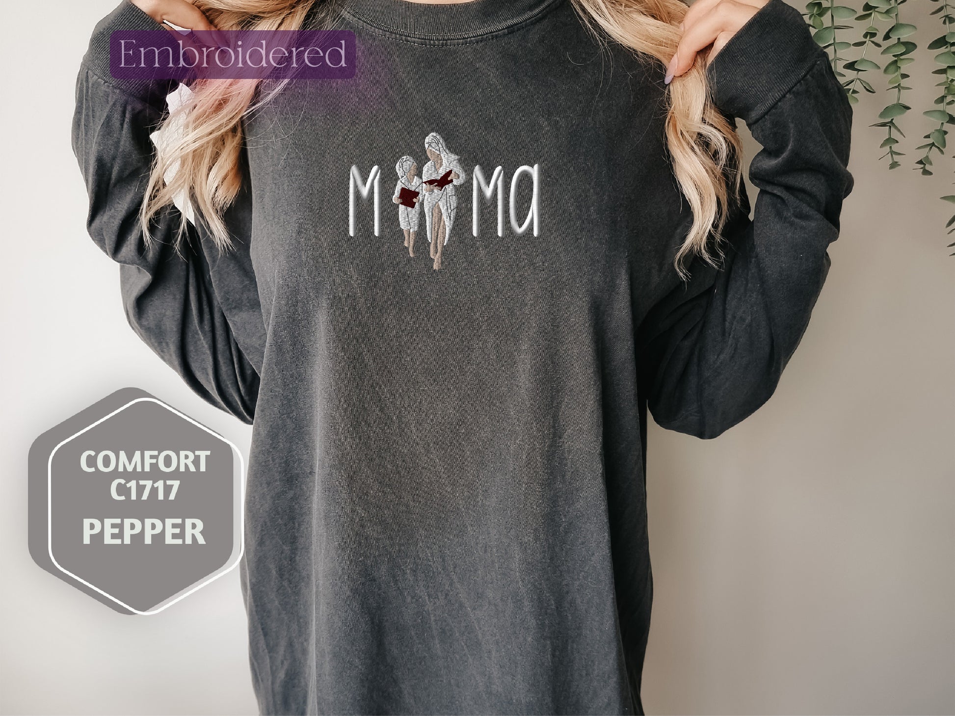 a woman wearing a black shirt with the word mama on it