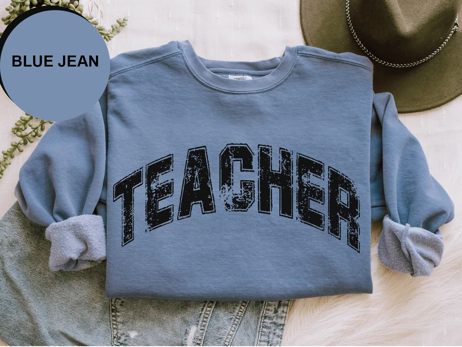 a blue jean shirt with the word teacher printed on it