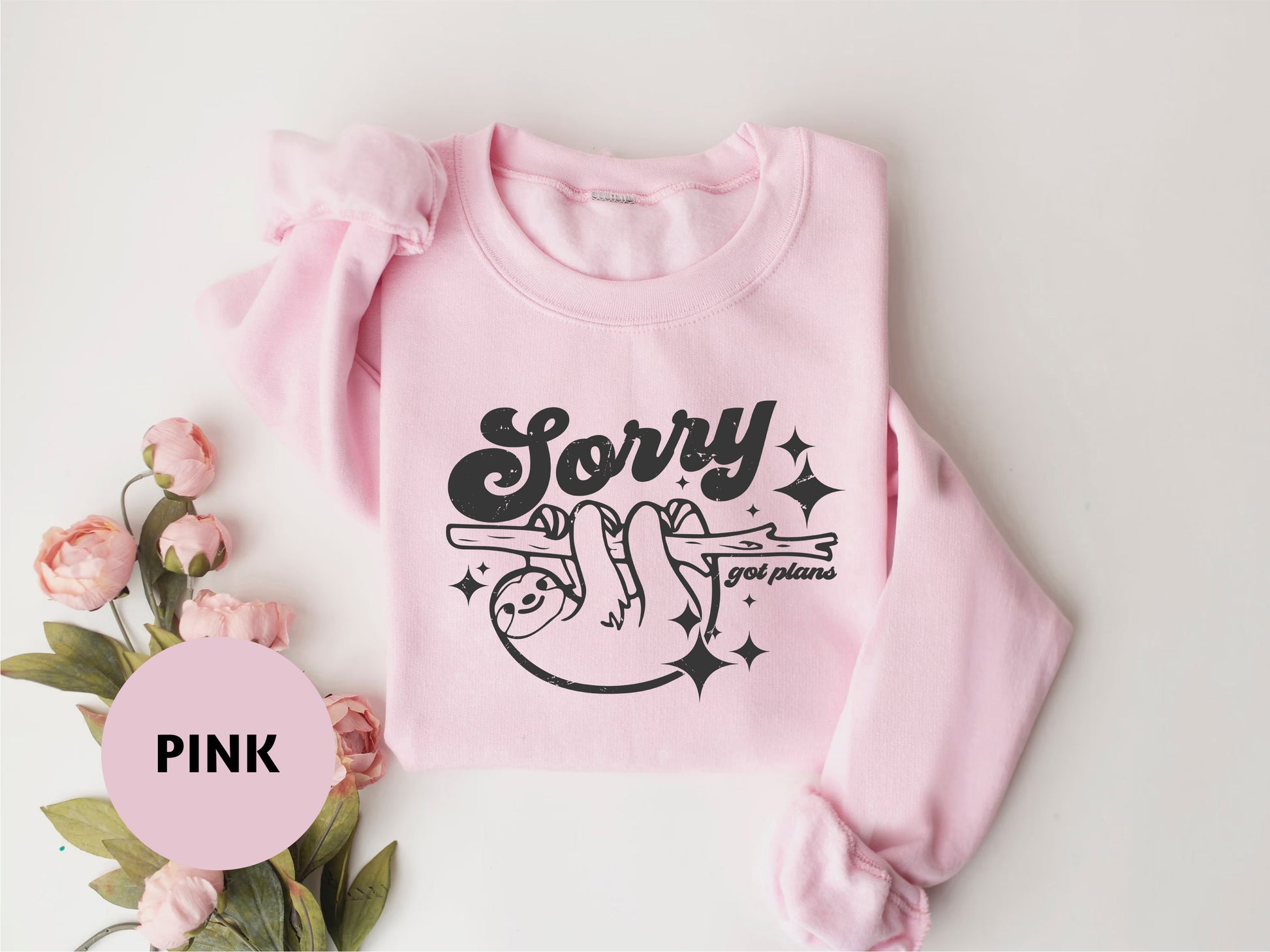 a pink sweater with a pink flower and a pink flower