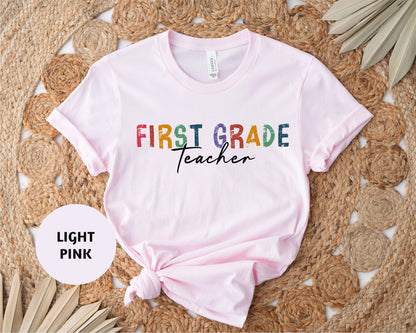 a pink shirt with the words first grade teacher on it