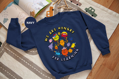 a blue sweatshirt with the words we are hungry for learning on it