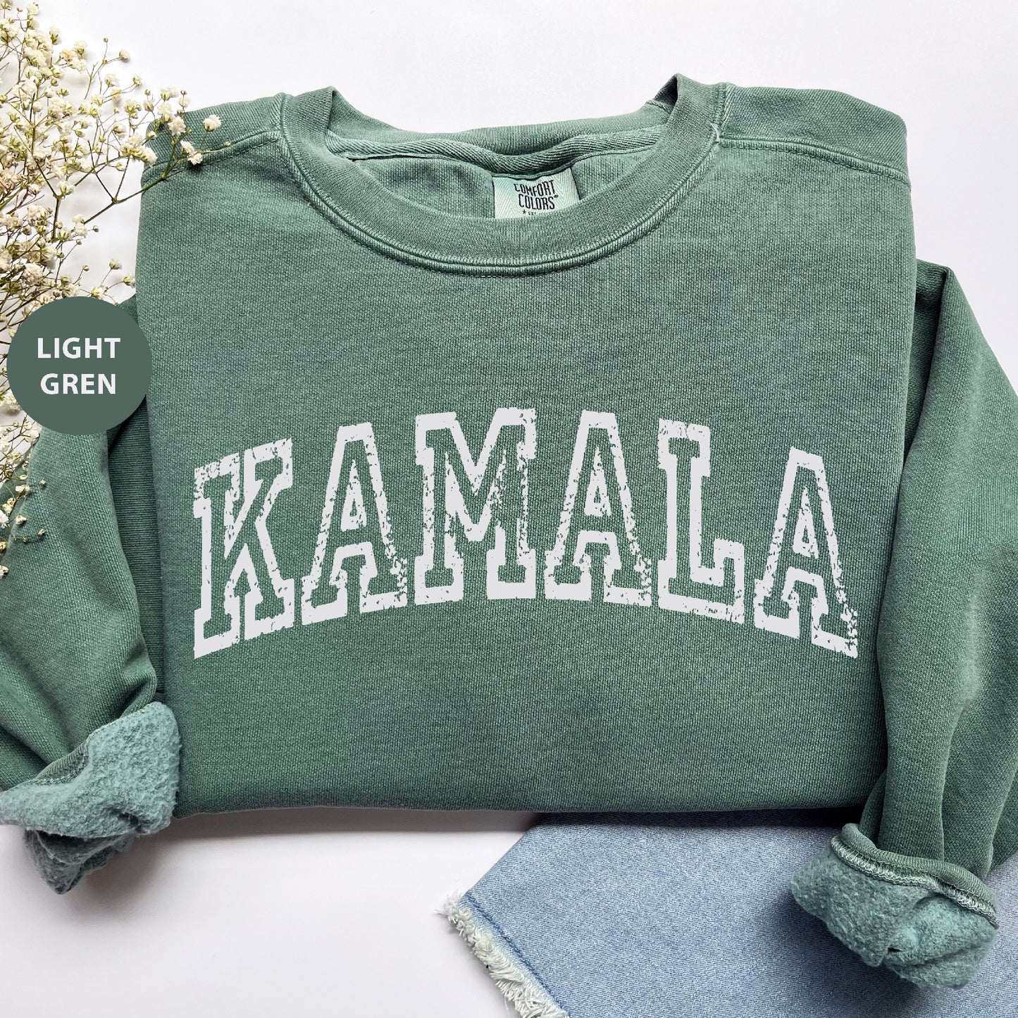 a green sweatshirt with the word kalamala printed on it