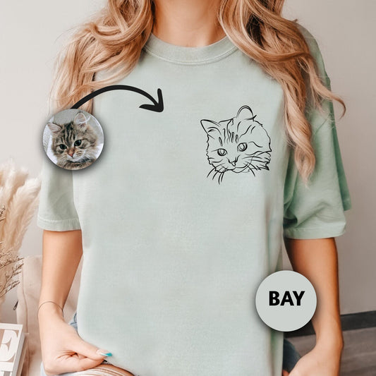 a woman wearing a t - shirt with a picture of a cat on it