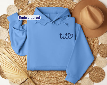 a blue hoodie with the word tico written on it