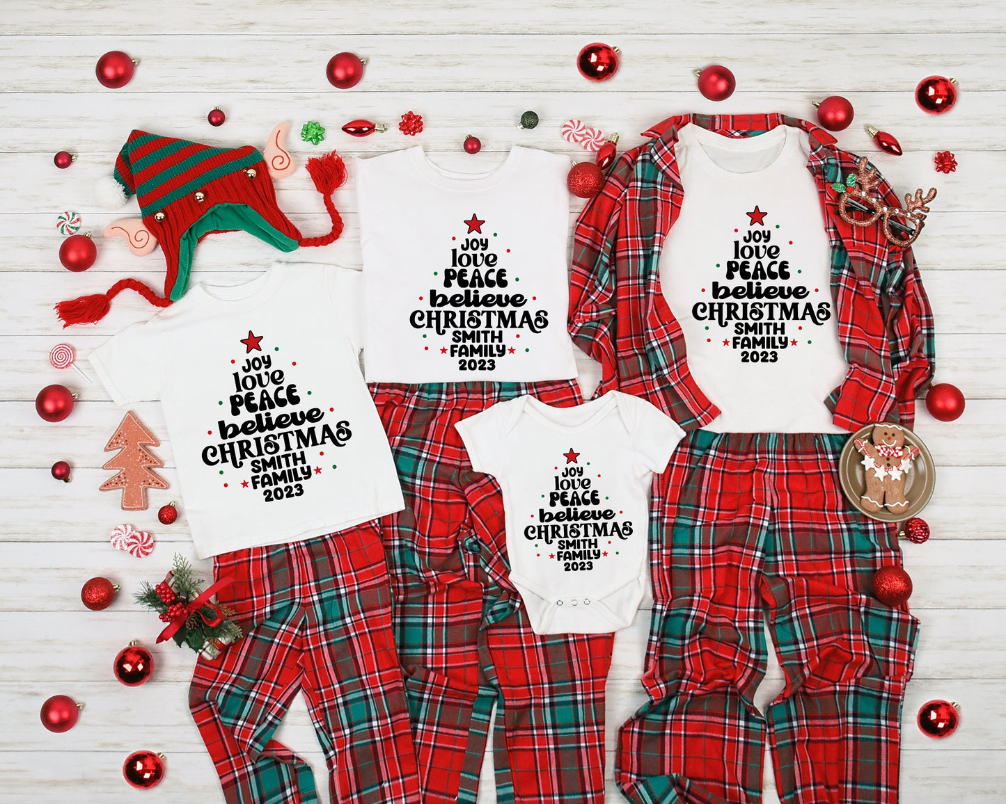 A collection of Christmas-themed pajamas and a festive hat, along with various ornaments and a gingerbread man, arranged on a white background.