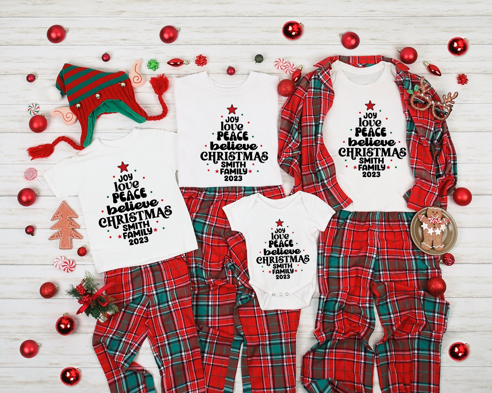 A collection of Christmas-themed pajamas and a festive hat, along with various ornaments and a gingerbread man, arranged on a white background.