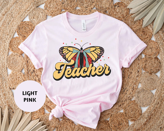 a pink shirt with a butterfly on it