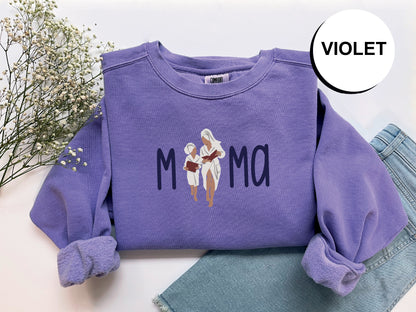 a purple sweatshirt with a picture of a woman reading a book