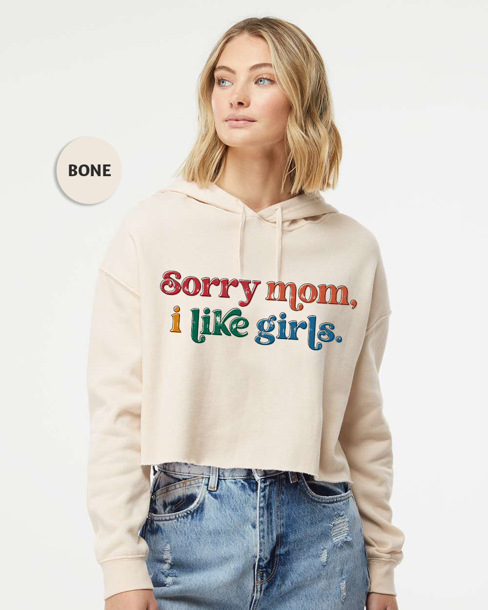 a woman wearing a white hoodie that says sorry mom, i like girls