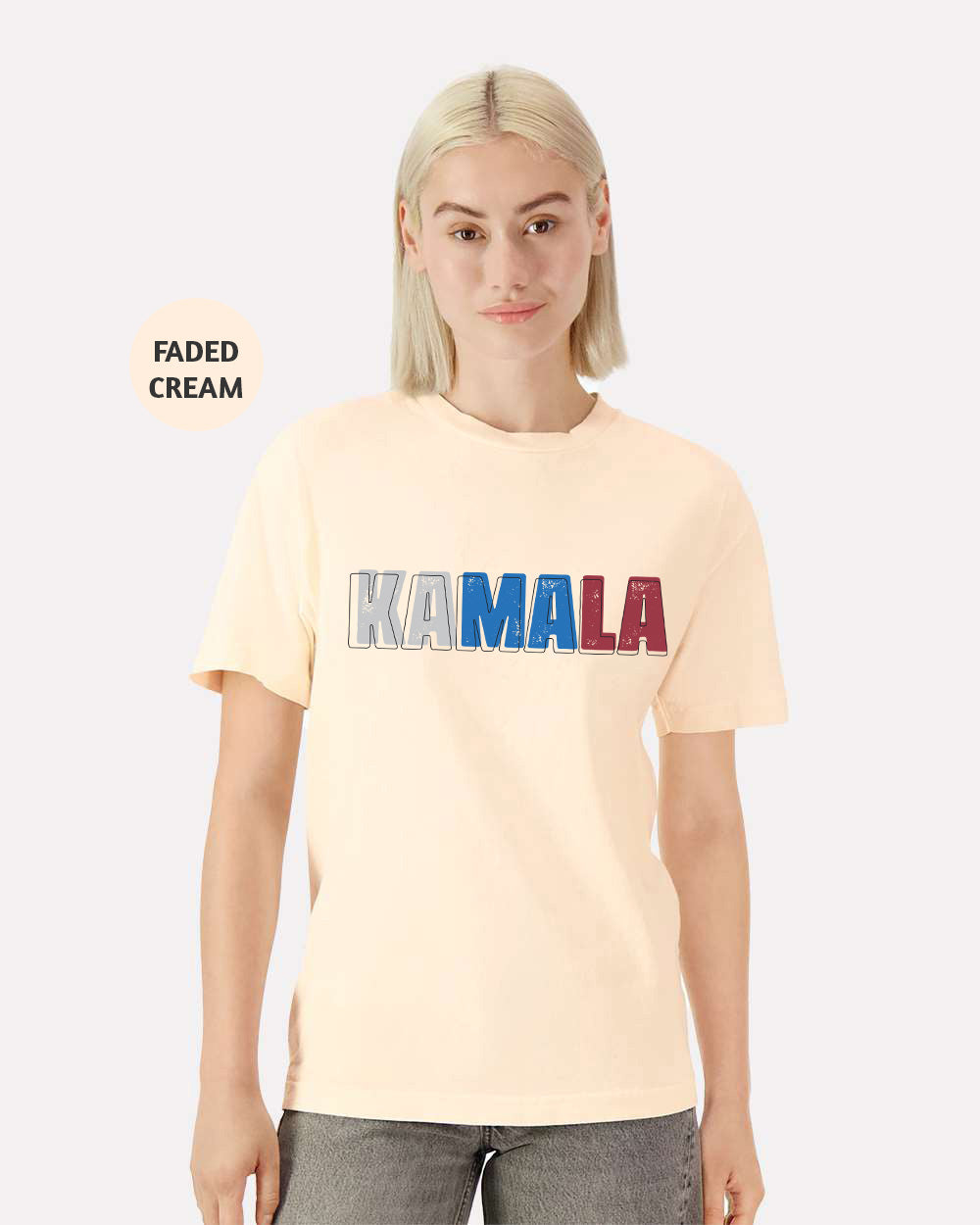 a woman with blonde hair wearing a cream shirt with the word kaamala printed