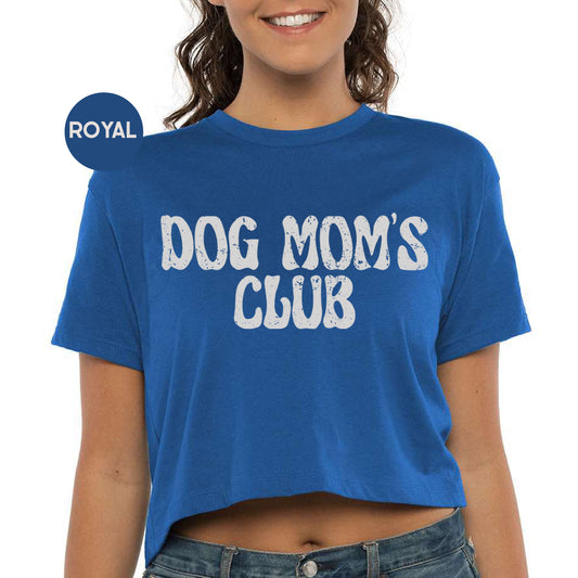 a woman wearing a blue dog mom's club shirt