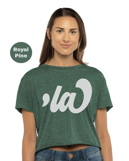 a woman wearing a green crop top with the royal pine logo on it