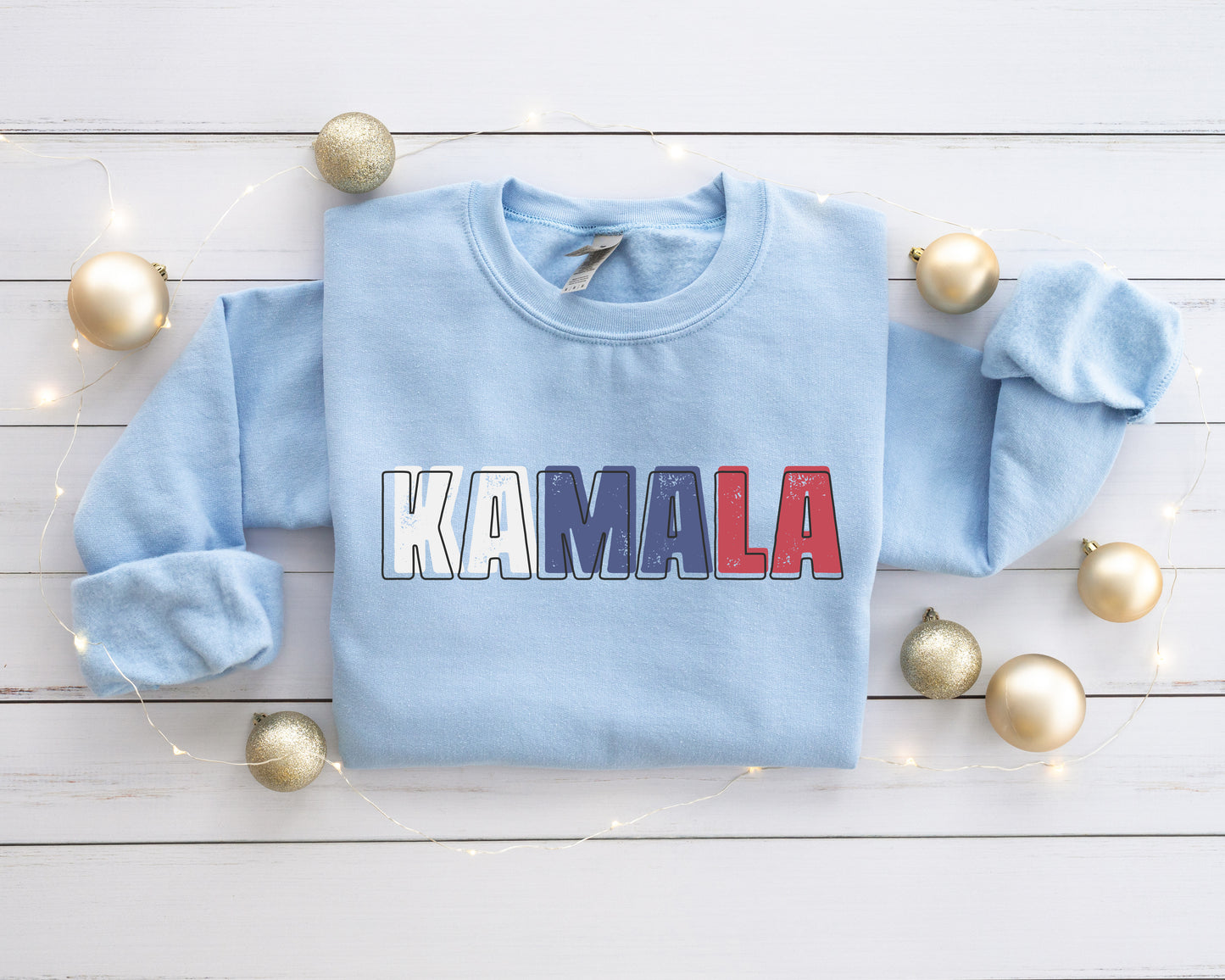 a light blue sweater with the word kalamala printed on it