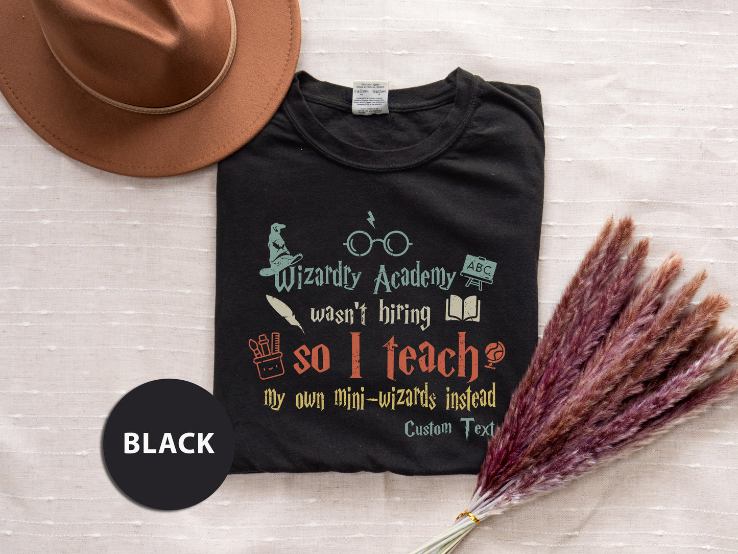 a hat, t - shirt, and a feather on a bed