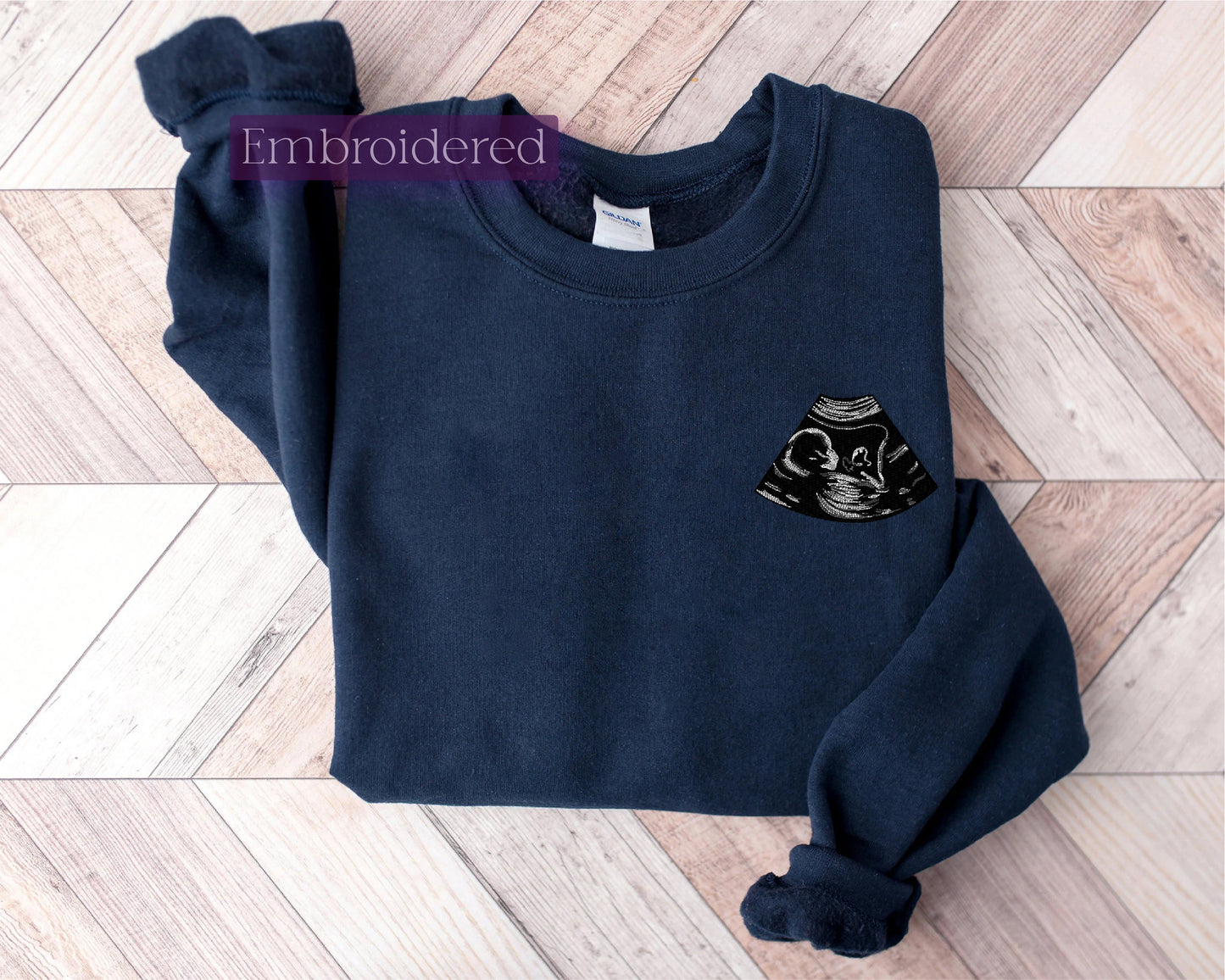 a blue sweater with a black cat on it