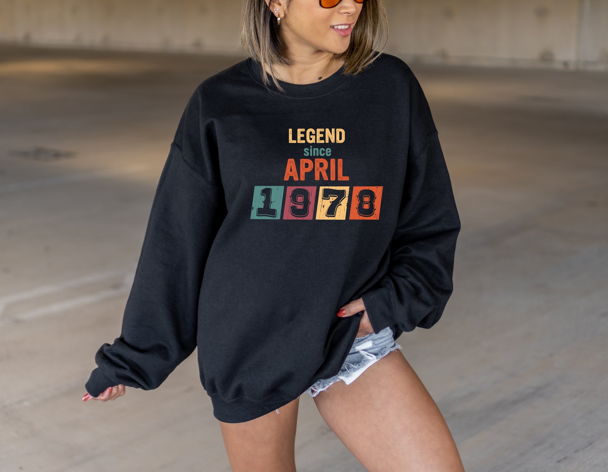 A woman wearing a black sweatshirt with the text "LEGEND since APRIL 1978" printed on it.