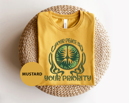 a yellow t - shirt with a picture of a tree on it