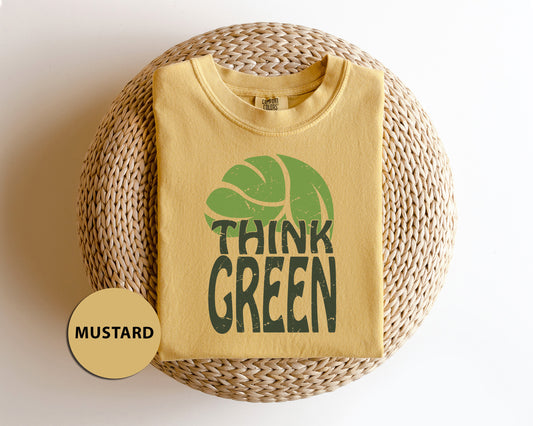 a t - shirt that says think green with a tennis ball on it