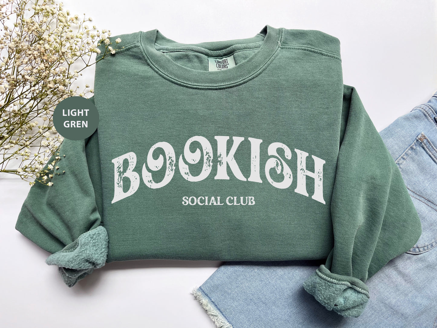 a green sweatshirt with a bookish social club on it