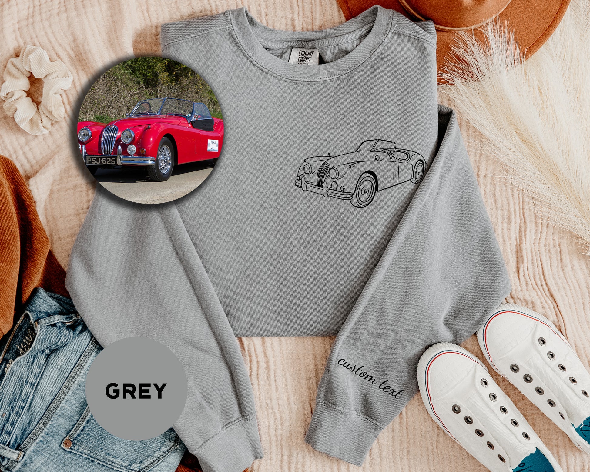 a grey sweatshirt with a picture of a red car and a pair of white shoes