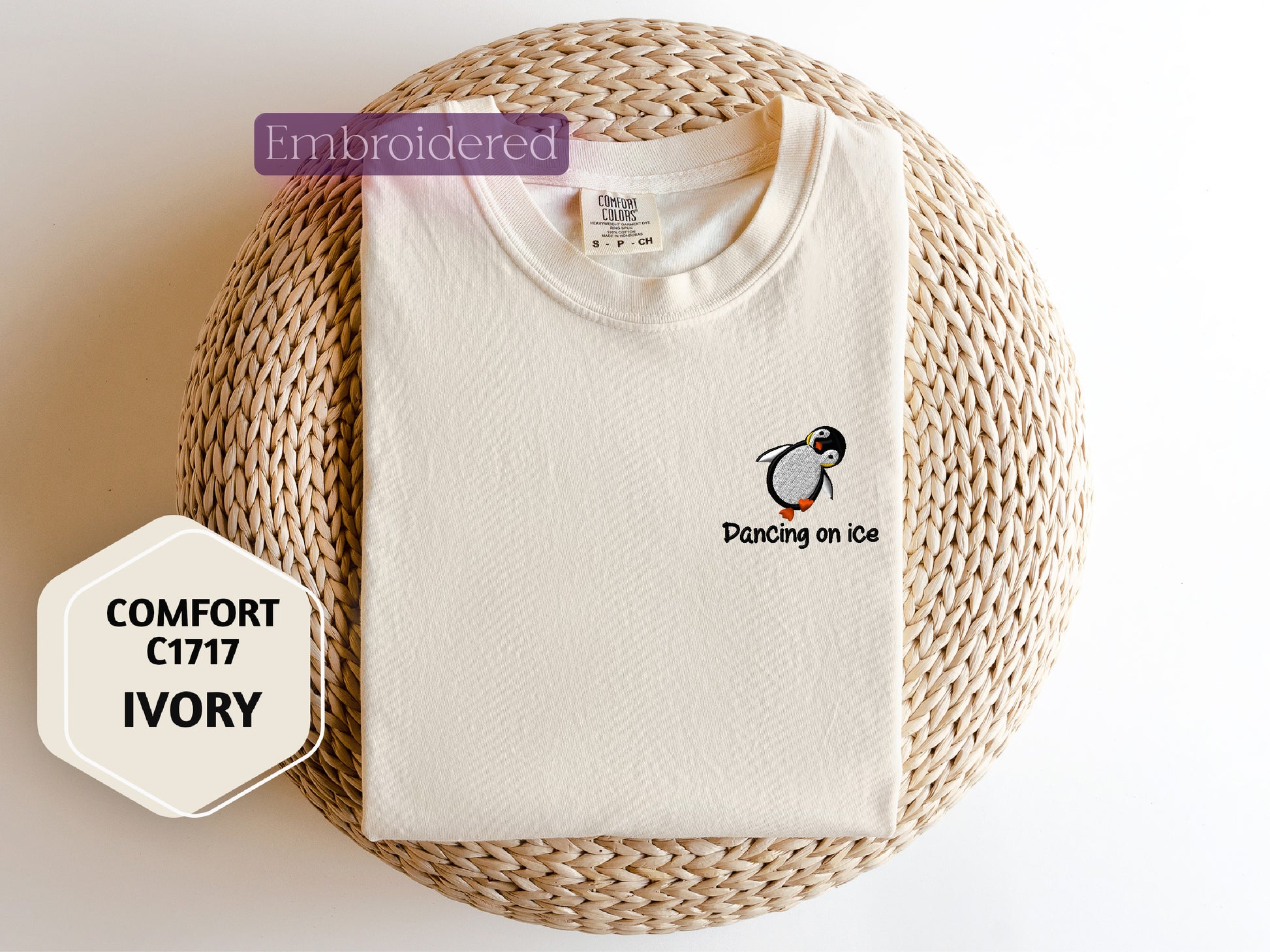 a white t - shirt with a penguin embroidered on it