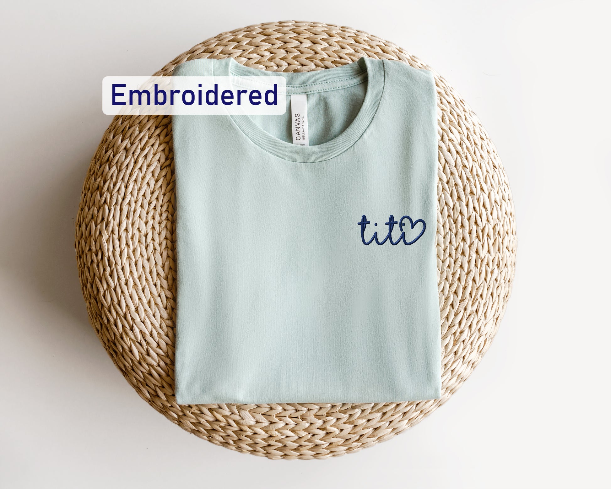 a t - shirt with the word embroidered on it