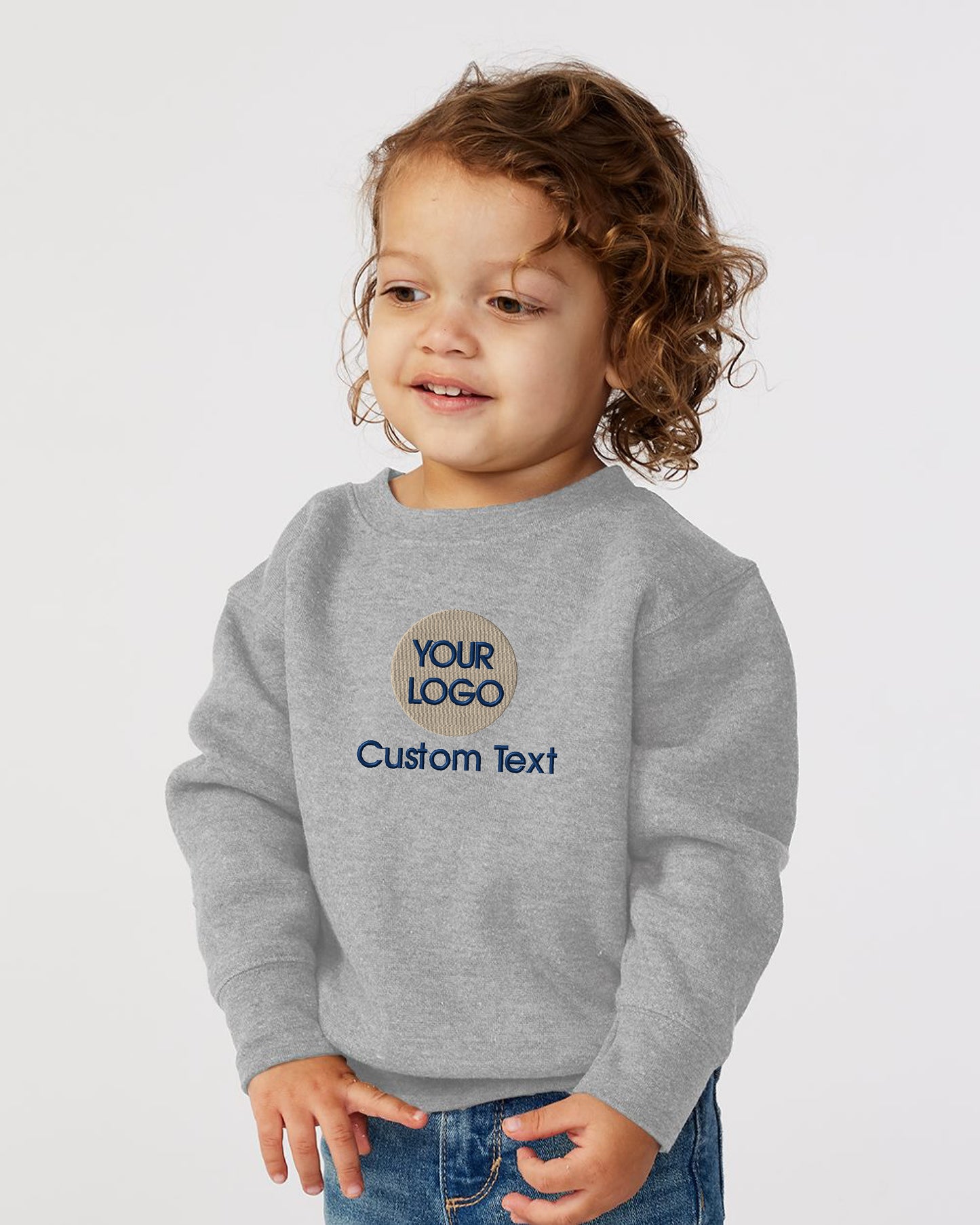 a little girl wearing a gray sweatshirt with the words your logo on it