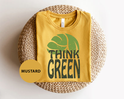 a yellow t - shirt with the words think green printed on it