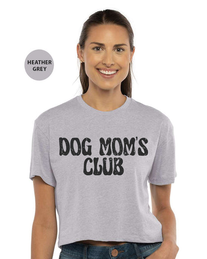 a woman wearing a dog mom's club t - shirt