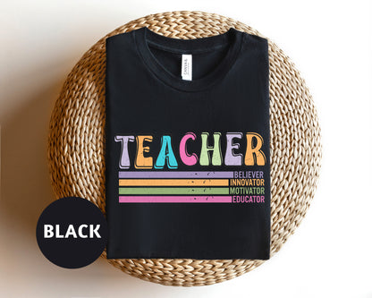 a black teacher t - shirt sitting on top of a wicker basket