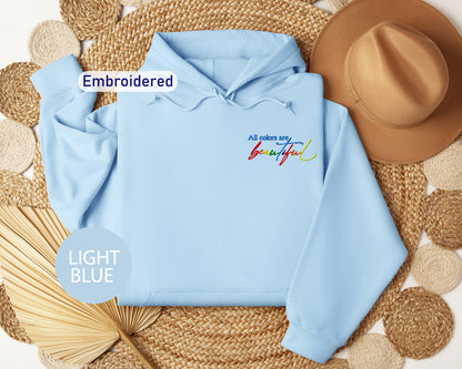 a light blue hoodie with the words embroidered on it