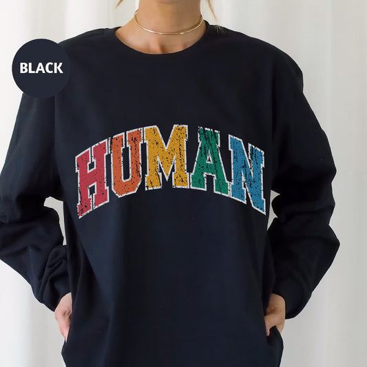 a woman wearing a black sweatshirt with the word human printed on it